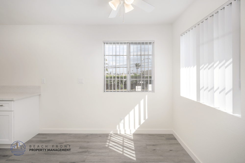 A room with a window and a ceiling fan.